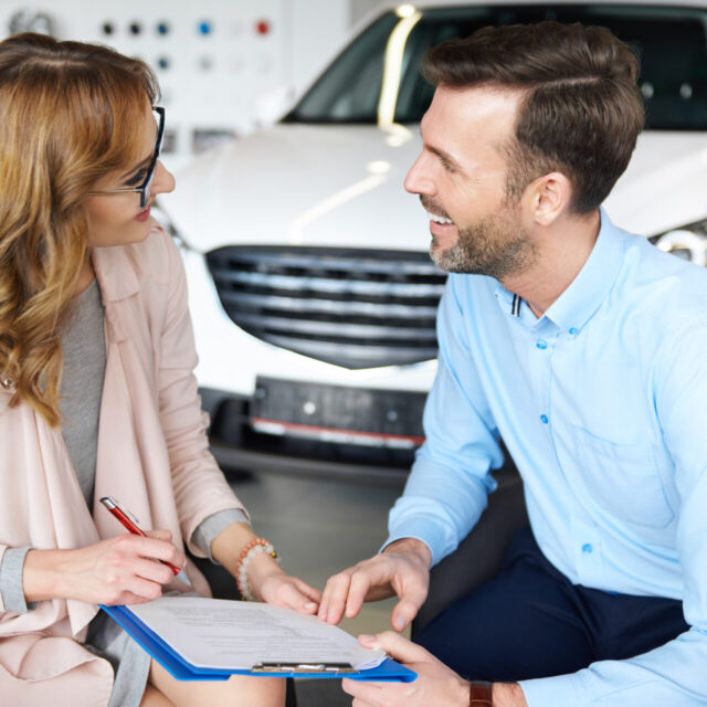 A vibrant image showcasing diverse individuals discussing car rental insurance in Dubai, symbolizing informed decision-making and customer interaction.